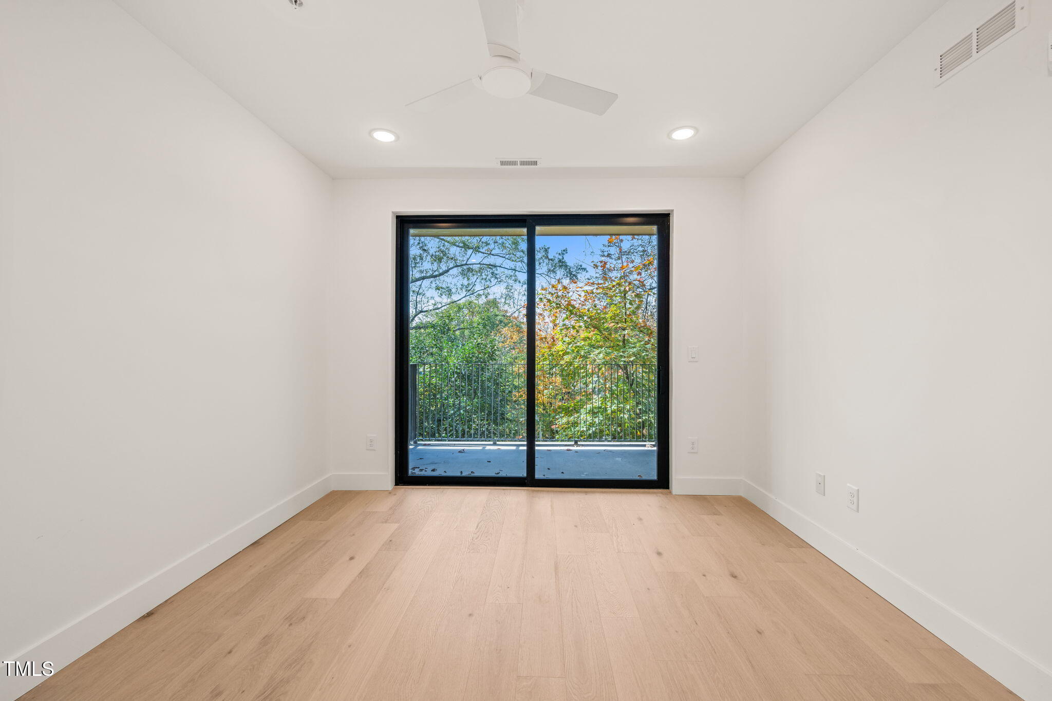 29 Enterprise Street, Unit 207 Raleigh, NC 27607 - Photo 9 of 36 wooden floor in an empty room with a window