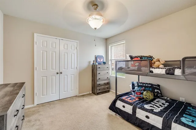 a bathroom with double vanity sink a toilet a mirror and shower