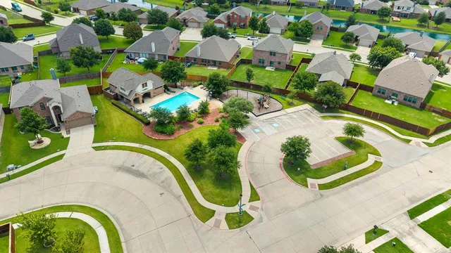 an aerial view of multiple houses with yard