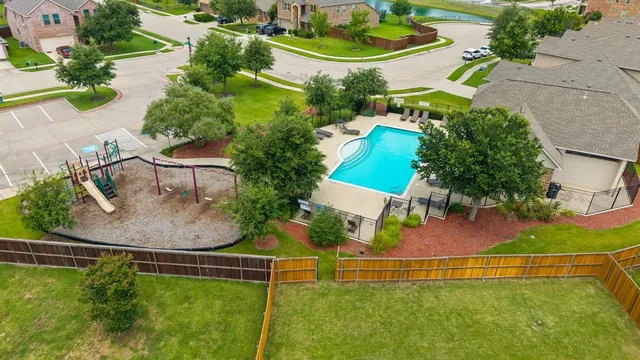 an aerial view of a house with outdoor space swimming pool and tennis court