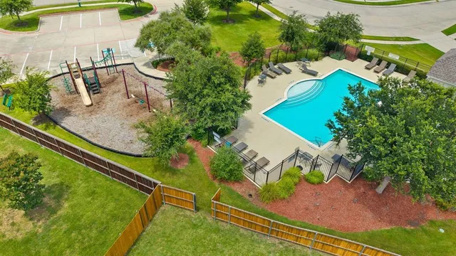 an aerial view of a house with outdoor space pool seating area and yard