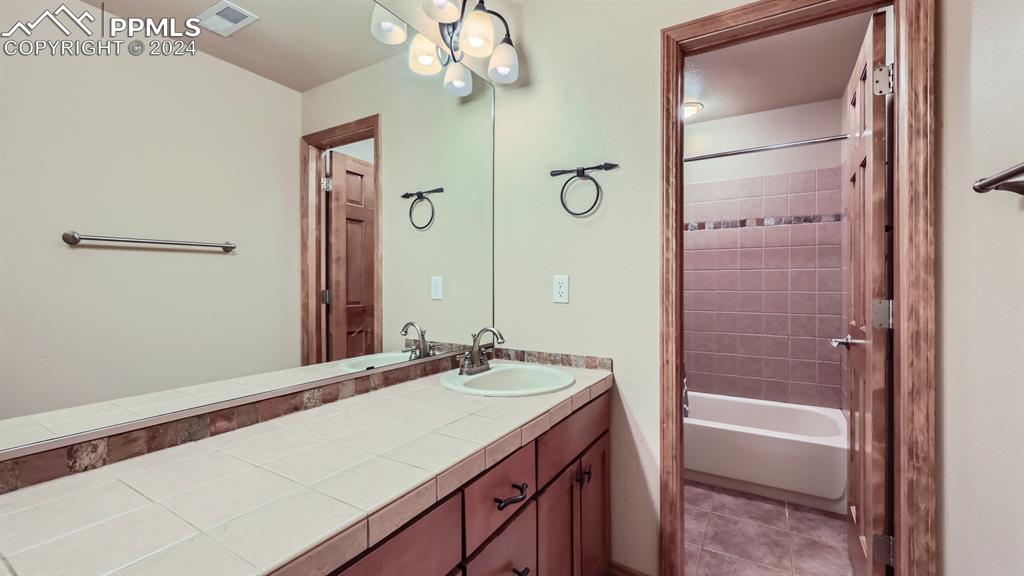 2644 Cinnabar Road Colorado Springs, CO 80921 - Photo 15 of 22 a bathroom with a bathtub a sink and a mirror