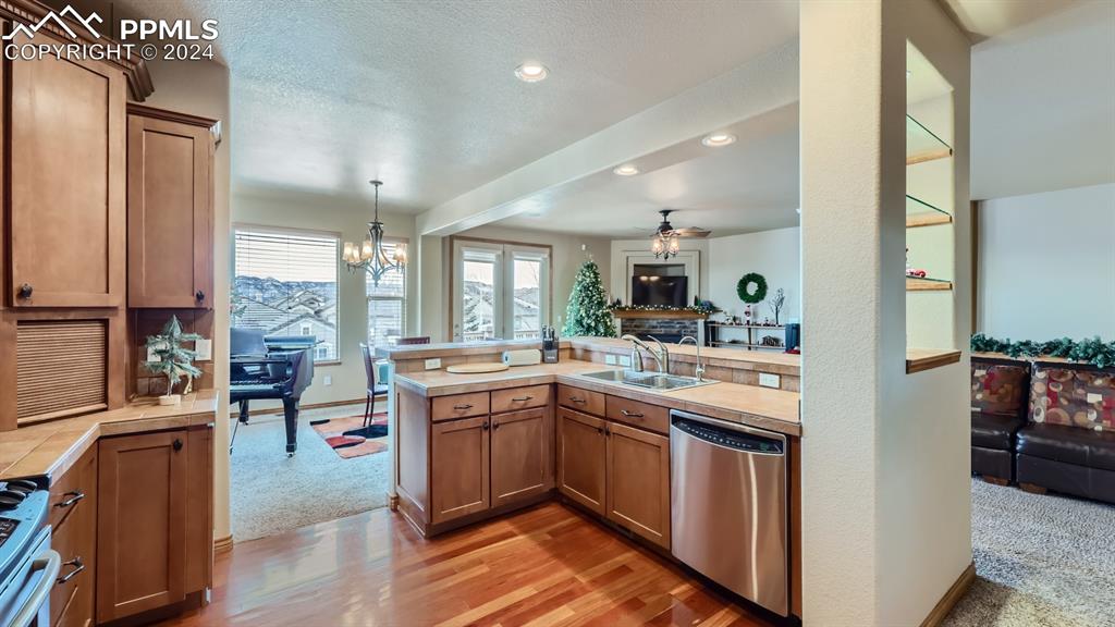 2644 Cinnabar Road Colorado Springs, CO 80921 - Photo 5 of 22 a kitchen with stainless steel appliances granite countertop sink stove top oven and cabinets