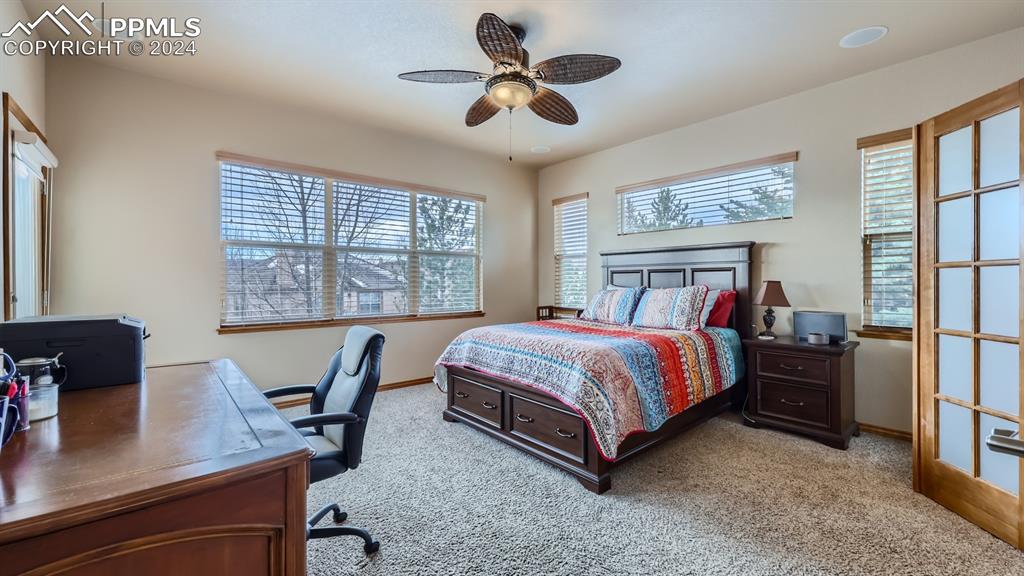 2644 Cinnabar Road Colorado Springs, CO 80921 - Photo 6 of 22 a bedroom with a bed and a desk