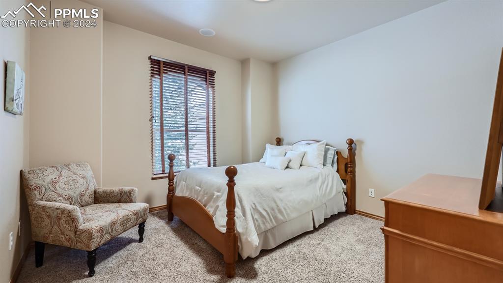 2644 Cinnabar Road Colorado Springs, CO 80921 - Photo 9 of 22 a bedroom with a bed and a couch