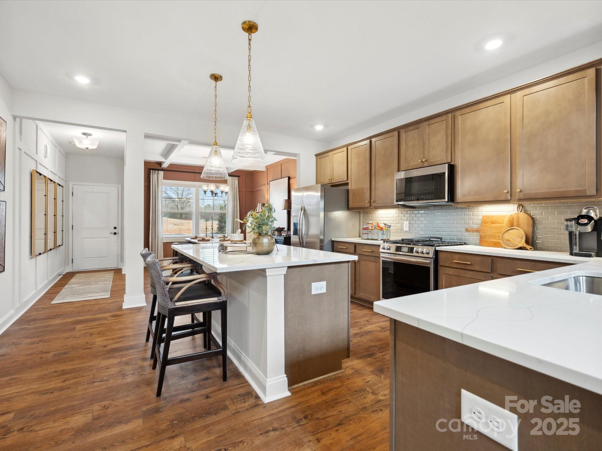 1018 Puddle Pond Road Indian Trail, NC 28079 - Photo 11 of 34 a kitchen with a sink a counter top space stainless steel appliances and cabinets