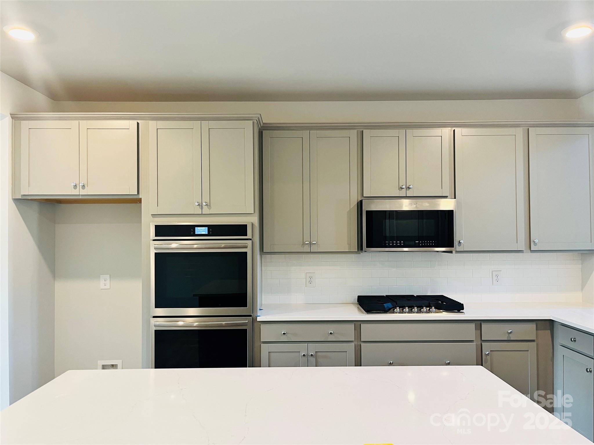 1018 Puddle Pond Road Indian Trail, NC 28079 - Photo 2 of 34 a kitchen with granite countertop white cabinets and stainless steel appliances