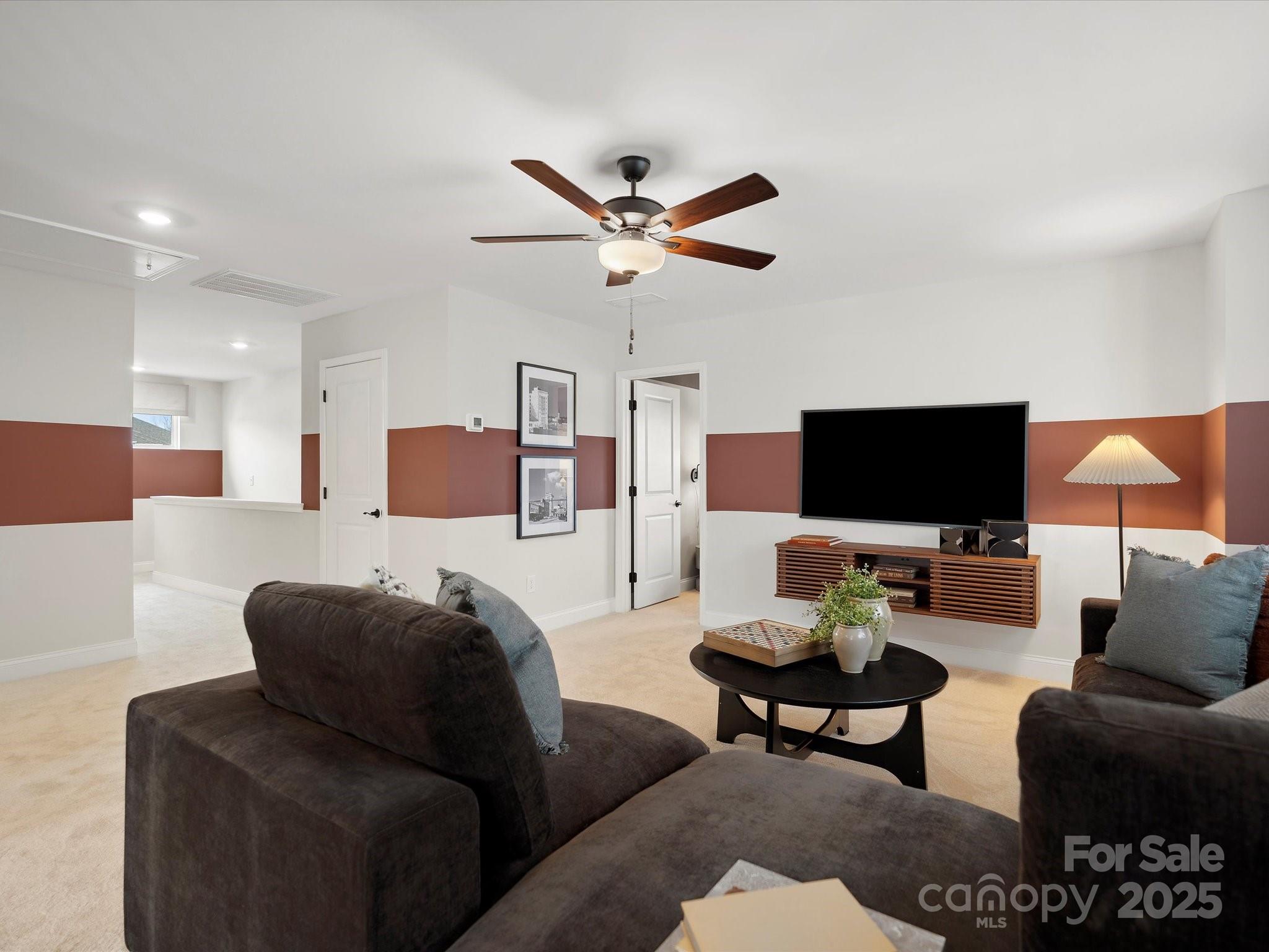 1018 Puddle Pond Road Indian Trail, NC 28079 - Photo 26 of 34 a living room with furniture and a flat screen tv