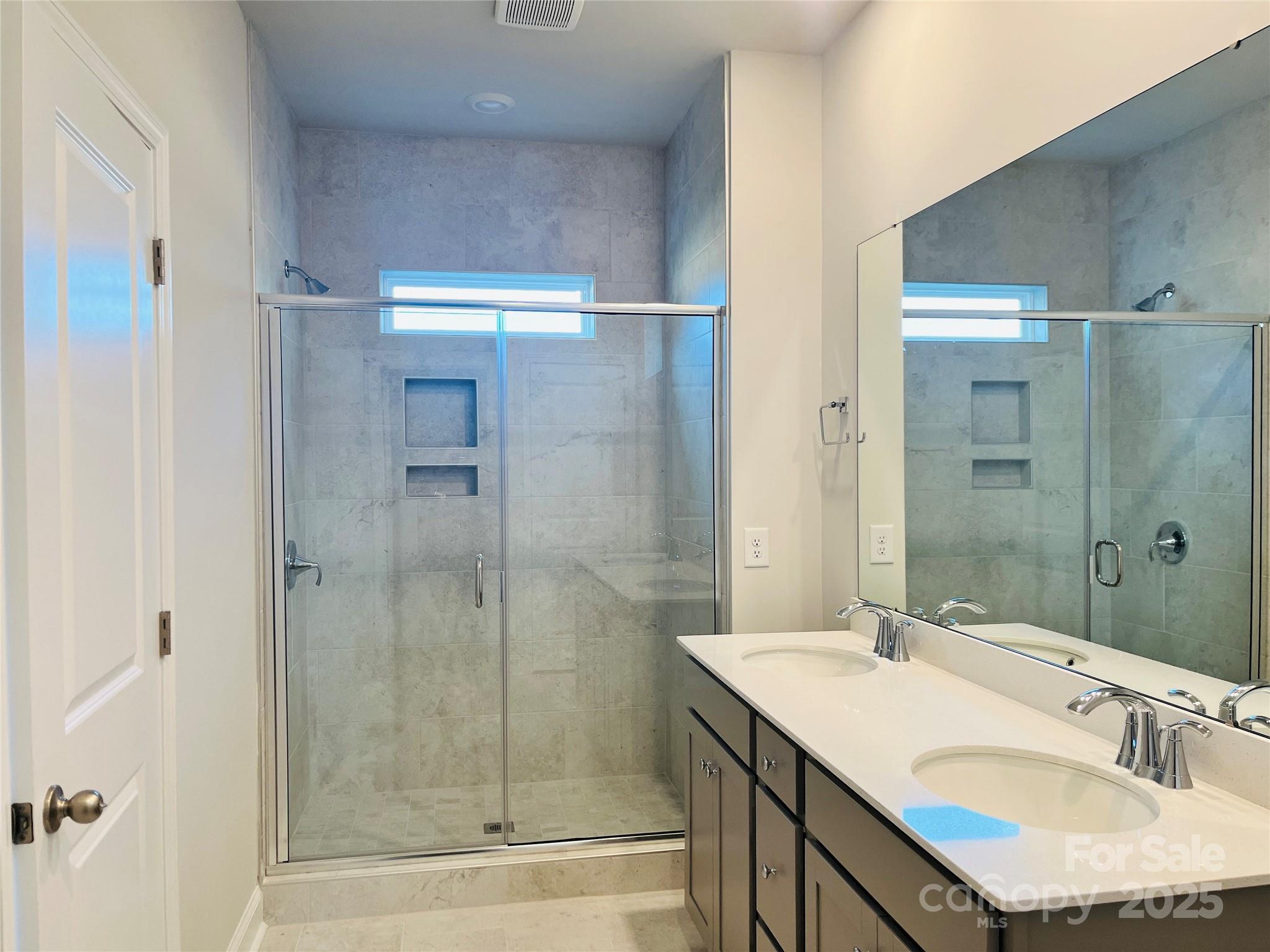 1018 Puddle Pond Road Indian Trail, NC 28079 - Photo 7 of 34 a bathroom with a shower sink vanity granite and mirror