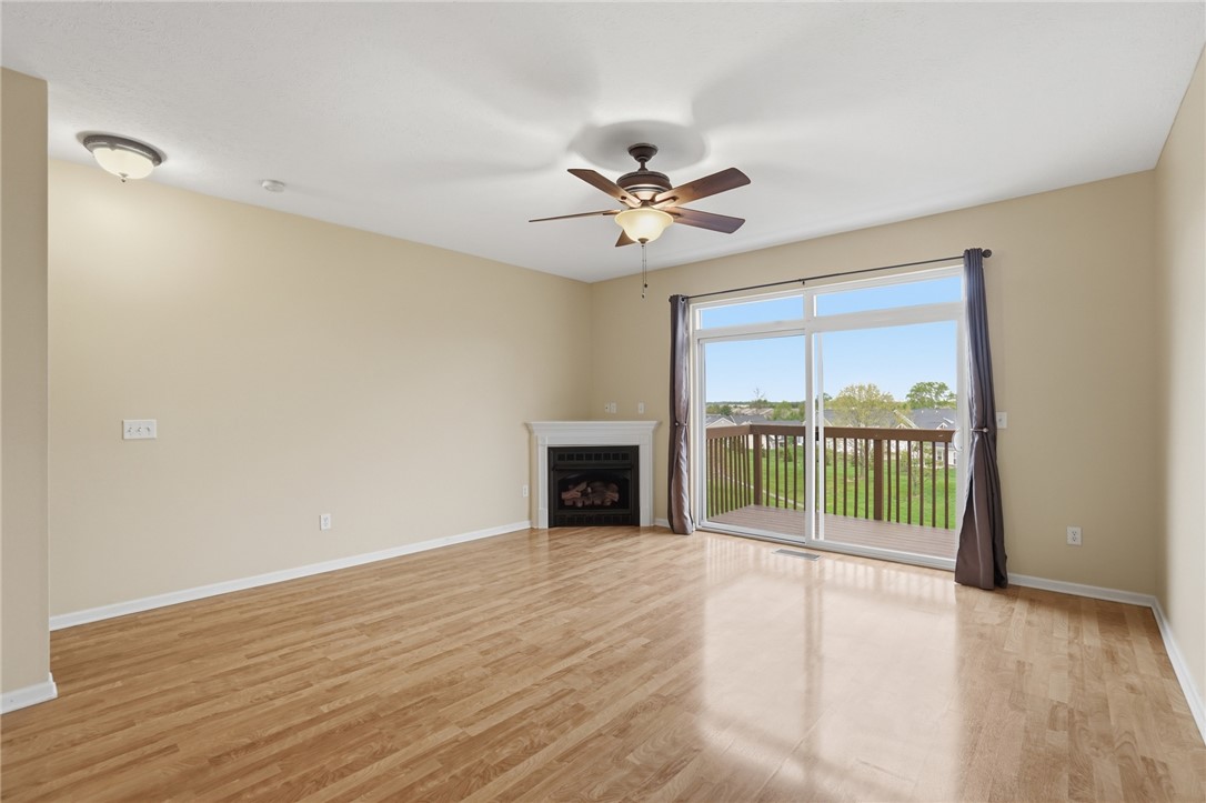 4324 Straight Arrow Road Dayton, OH 45430 - Photo 4 of 40 This bright living space features warm flooring, a cozy fireplace, and an expansive sliding glass door.