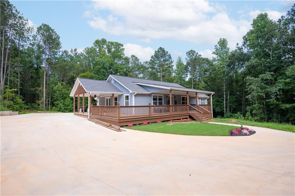 5618 Tyree Road Winston, GA 30187 - Photo 1 of 1 a house with trees in the background