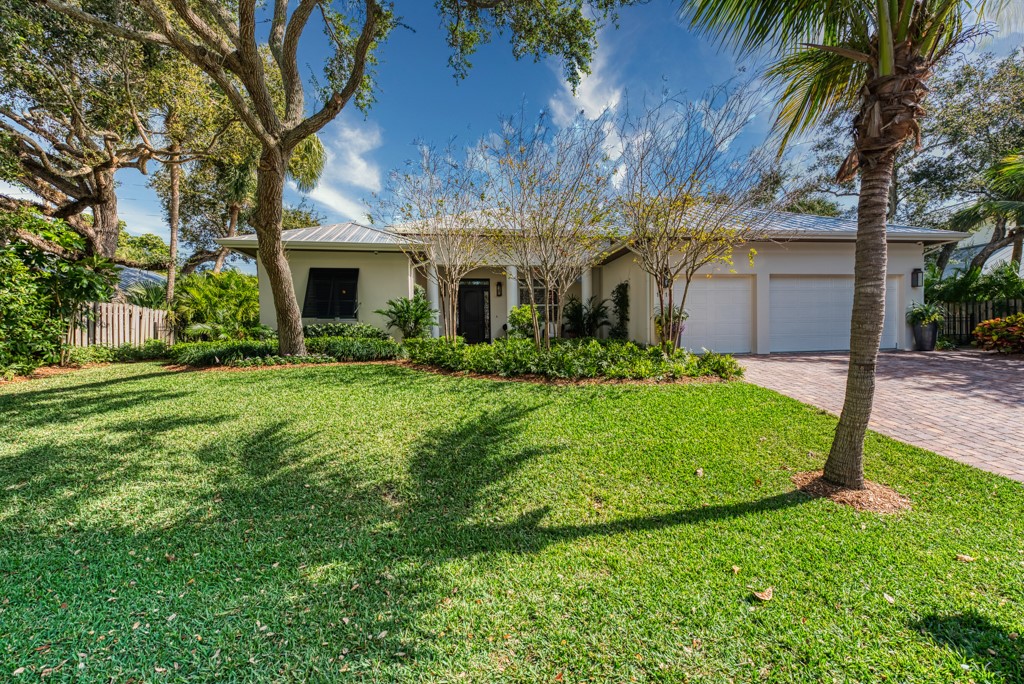 a front view of house with yard and green space