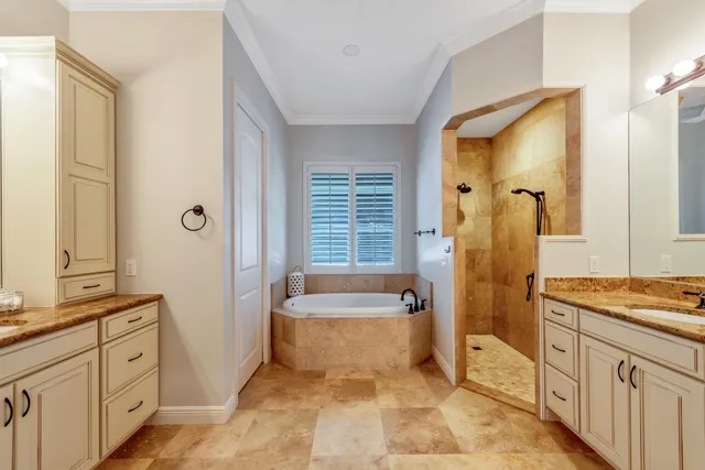 a spacious bathroom with a tub sink and mirror