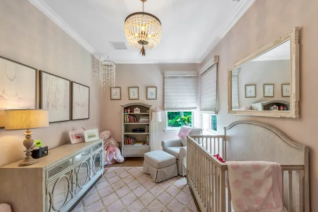 a bedroom with furniture a chandelier and a window