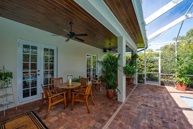 a view of a patio with table and chairs and potted plants