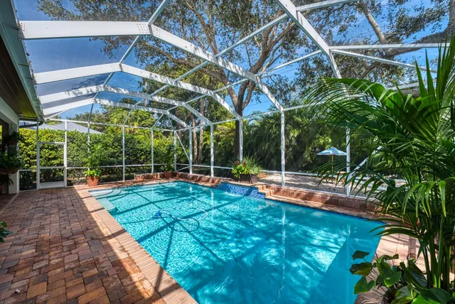 a view of a backyard with swimming pool
