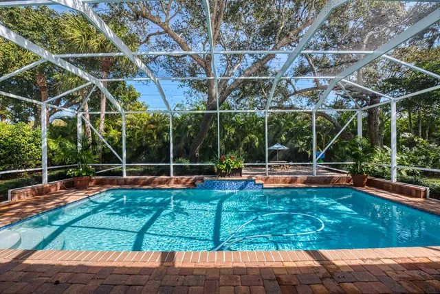 a view of a backyard with swimming pool