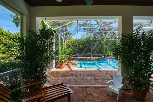 a view of a yard with plants and a patio