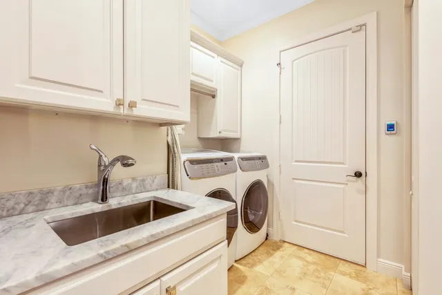 a kitchen with a sink a stove and cabinets