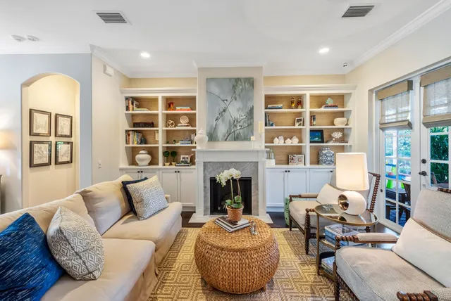 a living room with furniture fireplace and wooden floor