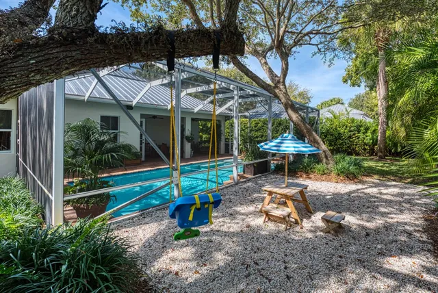 a view of a chair and table in backyard