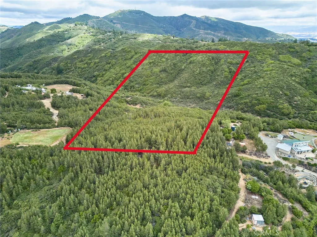 0 Maymens Flat Road Los Gatos, CA 95033 - Photo 1 of 1 a view of a lush green hillside and a houses
