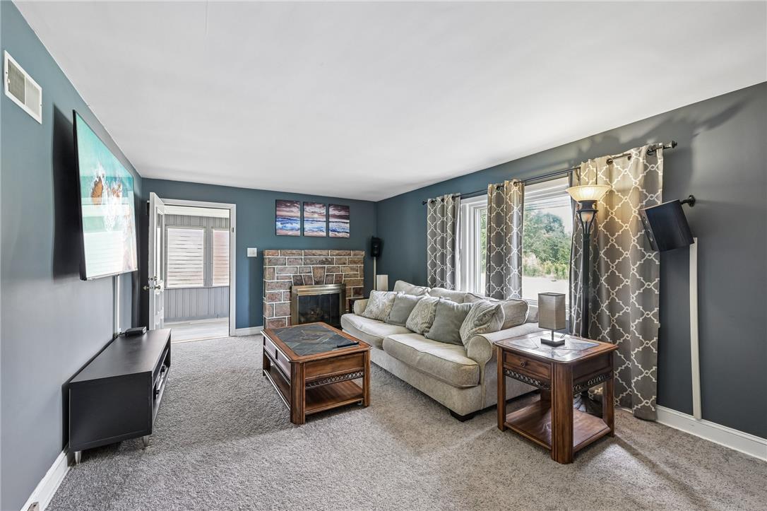 4065 Airport Road Allentown, PA 18109 - Photo 4 of 28 A cozy living space features a captivating stone fireplace, perfect for intimate gatherings.