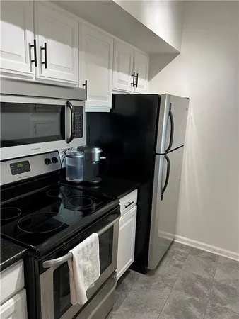 a kitchen with stainless steel appliances a stove a microwave and a refrigerator