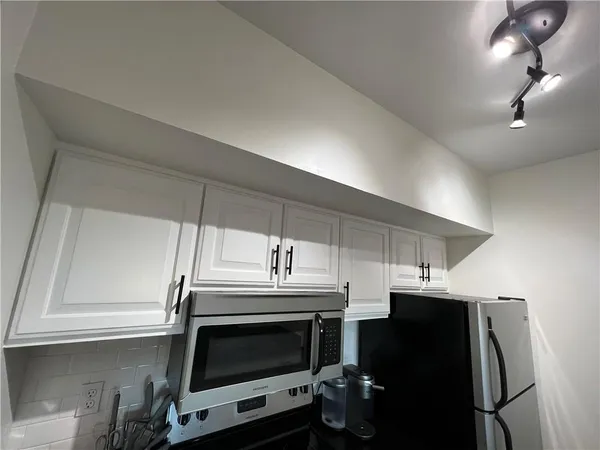 a kitchen with stainless steel appliances a stove a microwave and a refrigerator