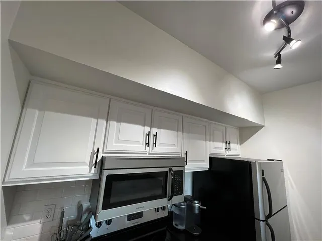 a kitchen with stainless steel appliances a stove a microwave and a refrigerator