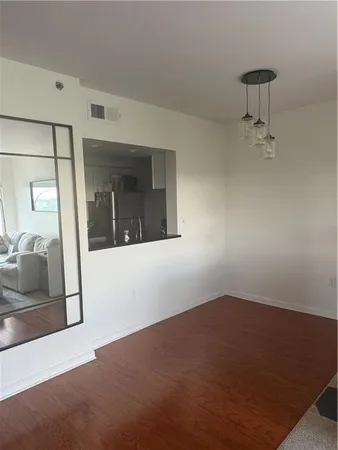 a utility room with wooden floor washer and dryer