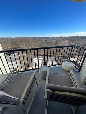 a balcony with a table and chairs