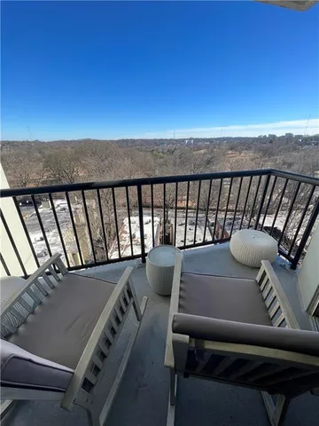 a balcony with a table and chairs