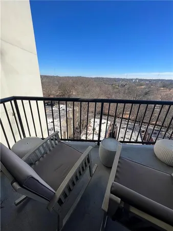 a view of a balcony with furniture