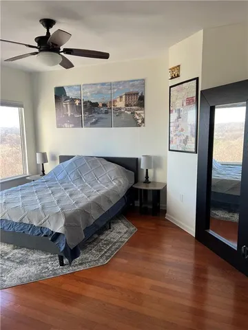 a bedroom with a large bed and a window