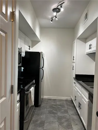 a kitchen with stainless steel appliances a refrigerator and cabinets