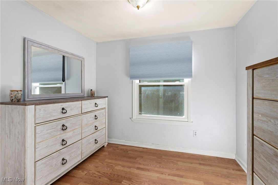 667 High Bridge Road Vermilion, OH 44089 - Photo 19 of 30 Bedroom featuring light wood-style floors and baseboards