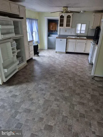 a view of a livingroom with furniture and a window