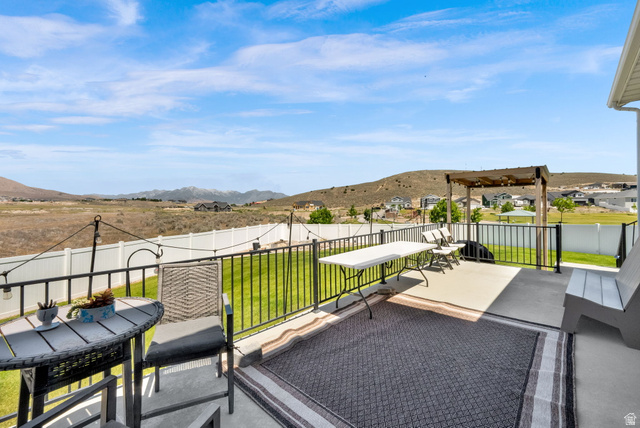 1857 Thunder Gulch Road Eagle Mountain, UT 84005 - Photo 46 of 50 Concrete patio featuring a black metal railing and a wood pergola