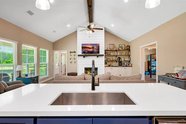 a kitchen with lots of clutter and cabinets