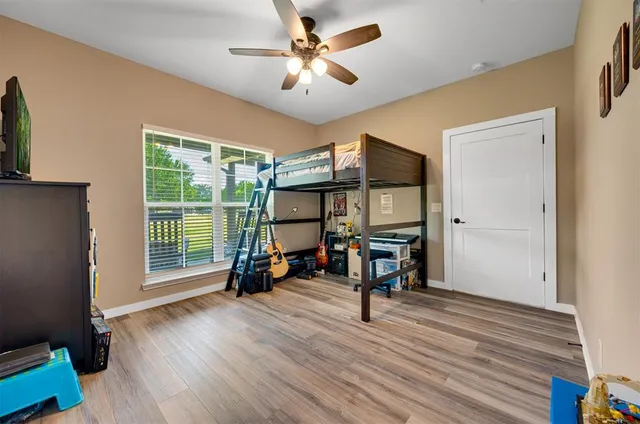 a view of a hallway with wooden floor and entryway