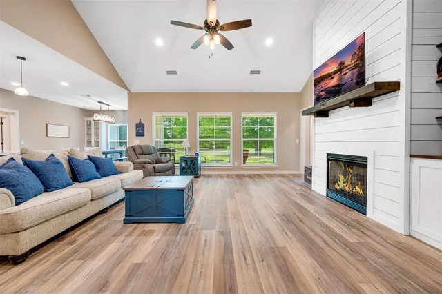 a living room with furniture and a wooden floor