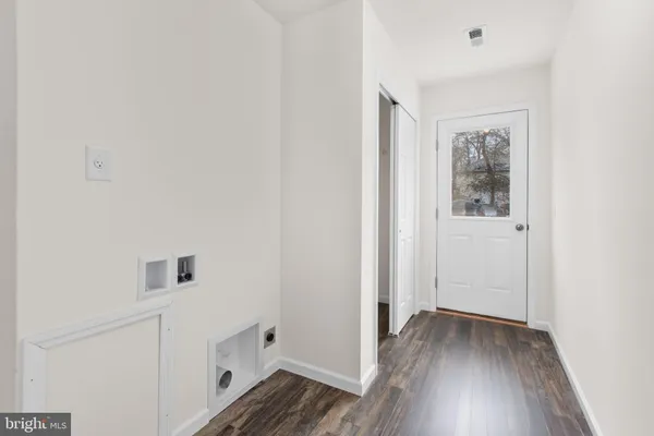 a view of hallway with wooden floor