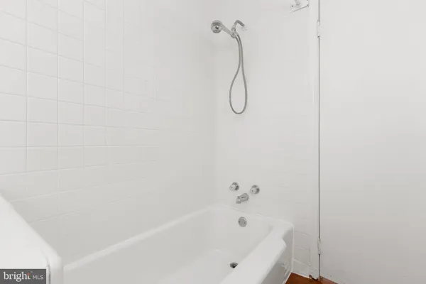 a bathroom with a bath tub with a shower