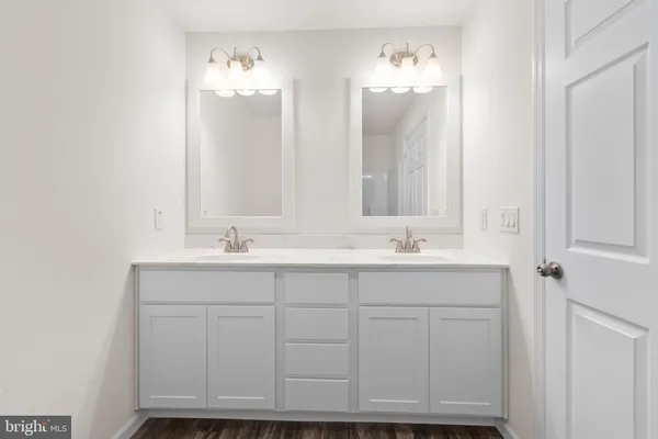 a bathroom with a sink vanity and a mirror
