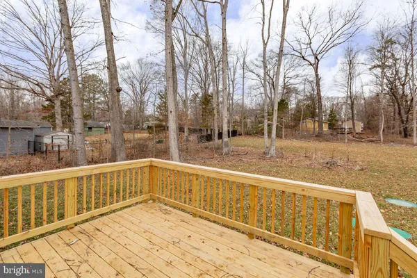 a view of balcony with wooden floor and fence