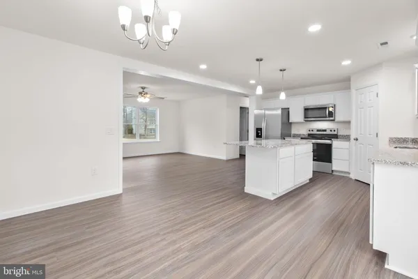 a view of a kitchen with a dishwasher cabinets and wooden floor