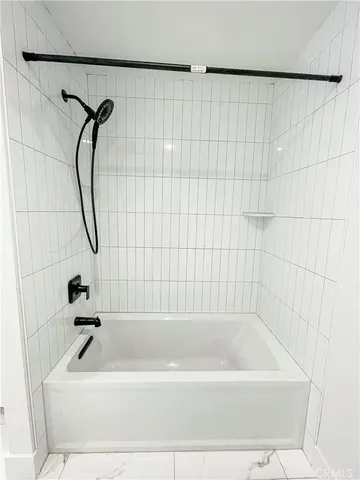 a bathroom with a bath tub with a shower
