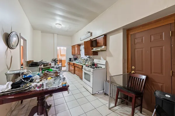 a large kitchen with a table chairs and a refrigerator