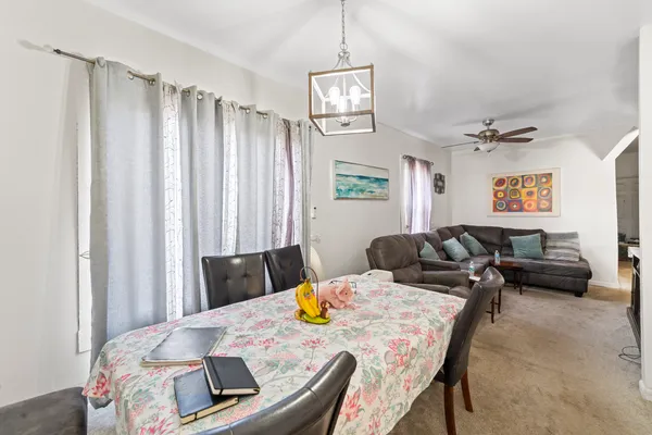 a living room with furniture and a chandelier